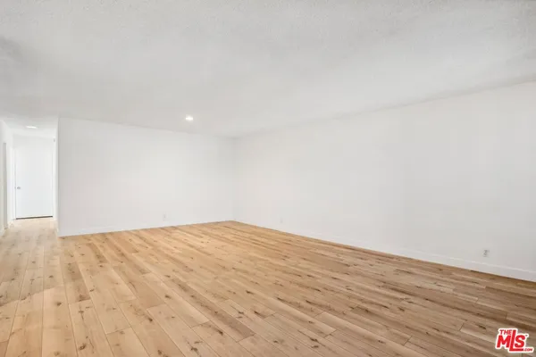 a kitchen with stainless steel appliances granite countertop a refrigerator a sink and a stove