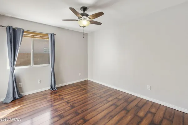 a view of an empty room with wooden floor