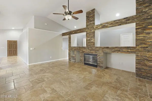 a view of an empty room with a fireplace