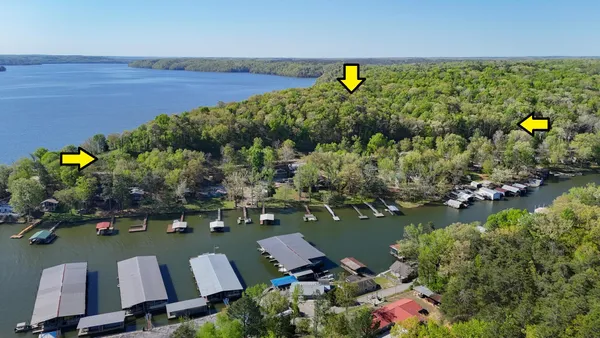 an aerial view of a houses with a lake view