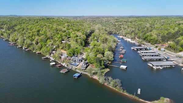 an aerial view of a house with a yard