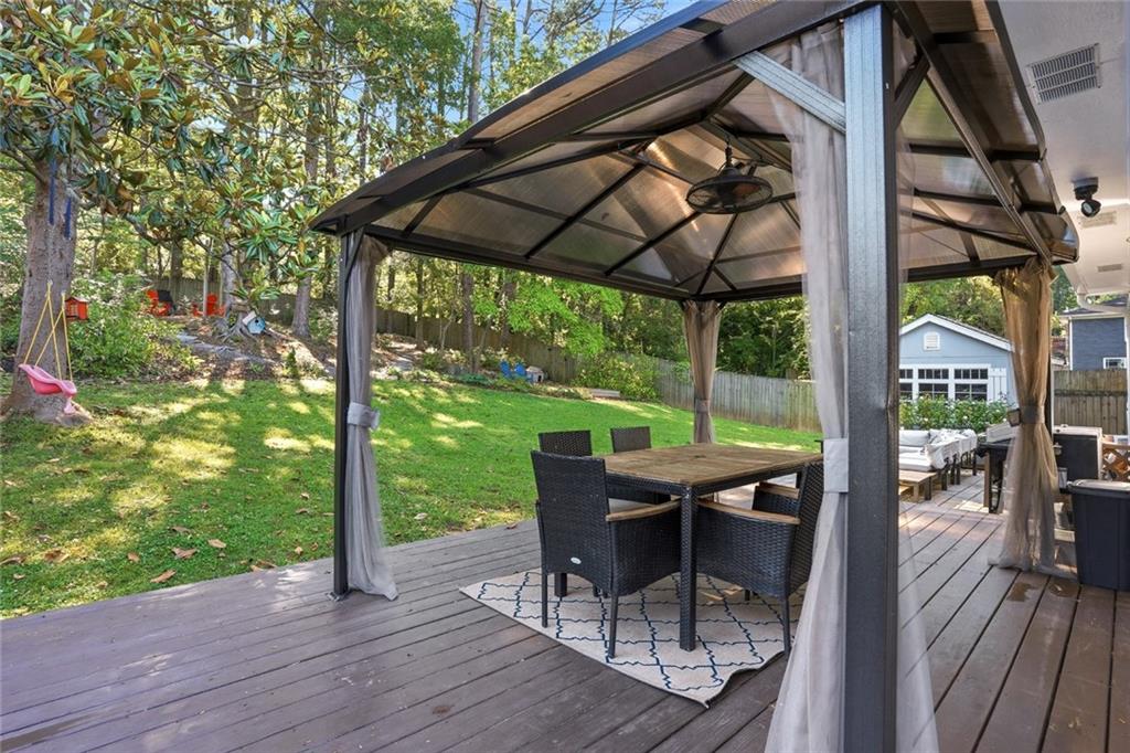 1430 Thomas Road Decatur, GA 30030 - Photo 31 of 42 a view of a patio with table and chairs under an umbrella with wooden floor