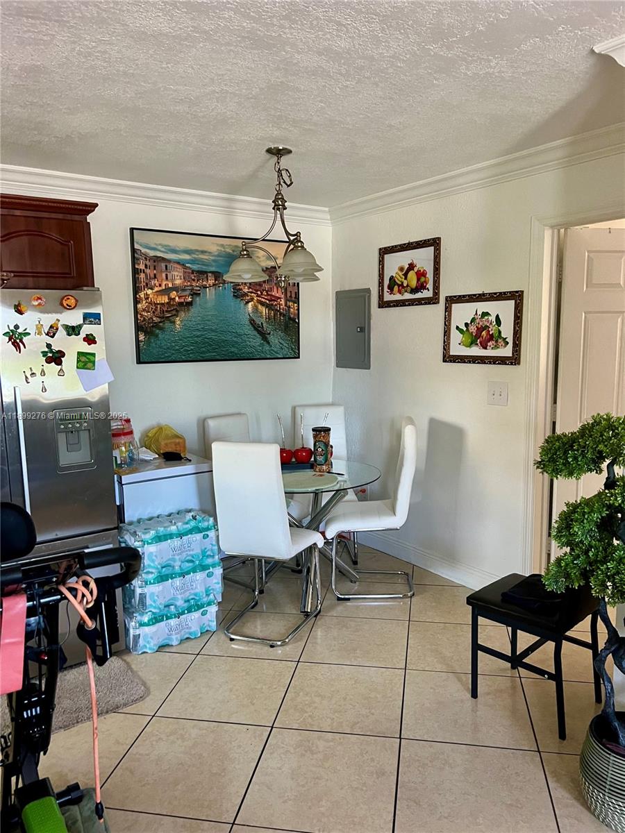 855 West 29th Street, Unit 11 Hialeah, FL 33012 - Photo 5 of 11 a living room with furniture and a flat screen tv