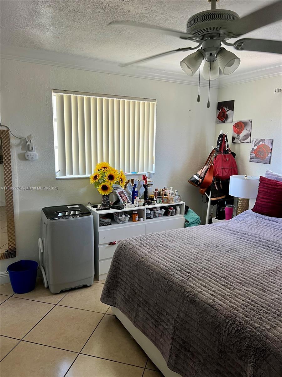 855 West 29th Street, Unit 11 Hialeah, FL 33012 - Photo 6 of 11 a bedroom with a bed and a chandelier