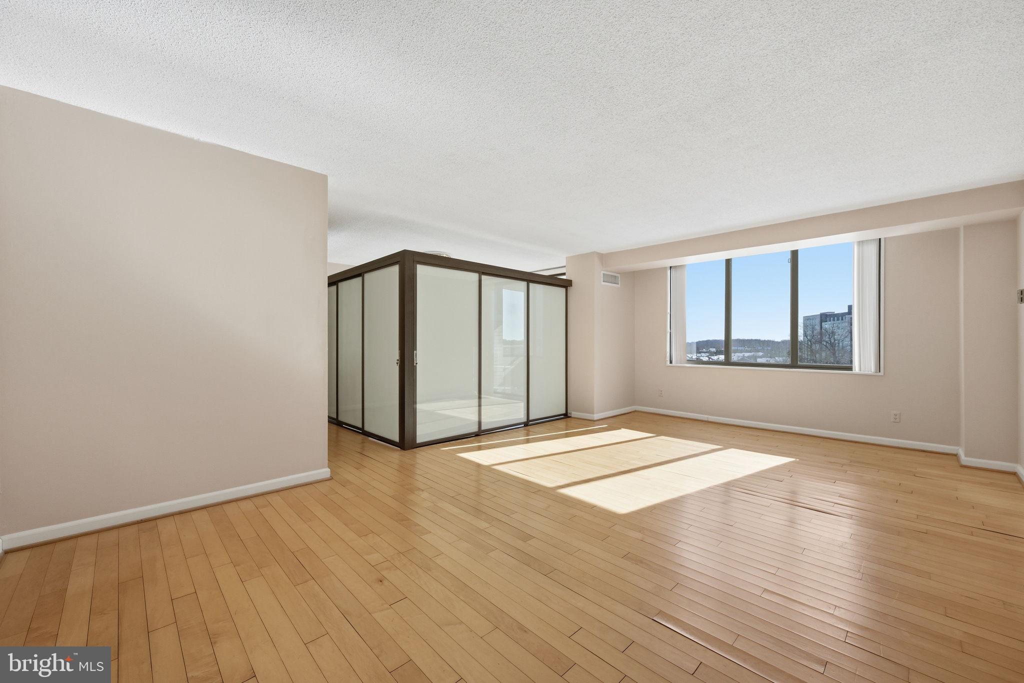 5225 Pooks Hill Road, Unit 519N Bethesda, MD 20814 - Photo 11 of 56 an empty room with wooden floor and windows