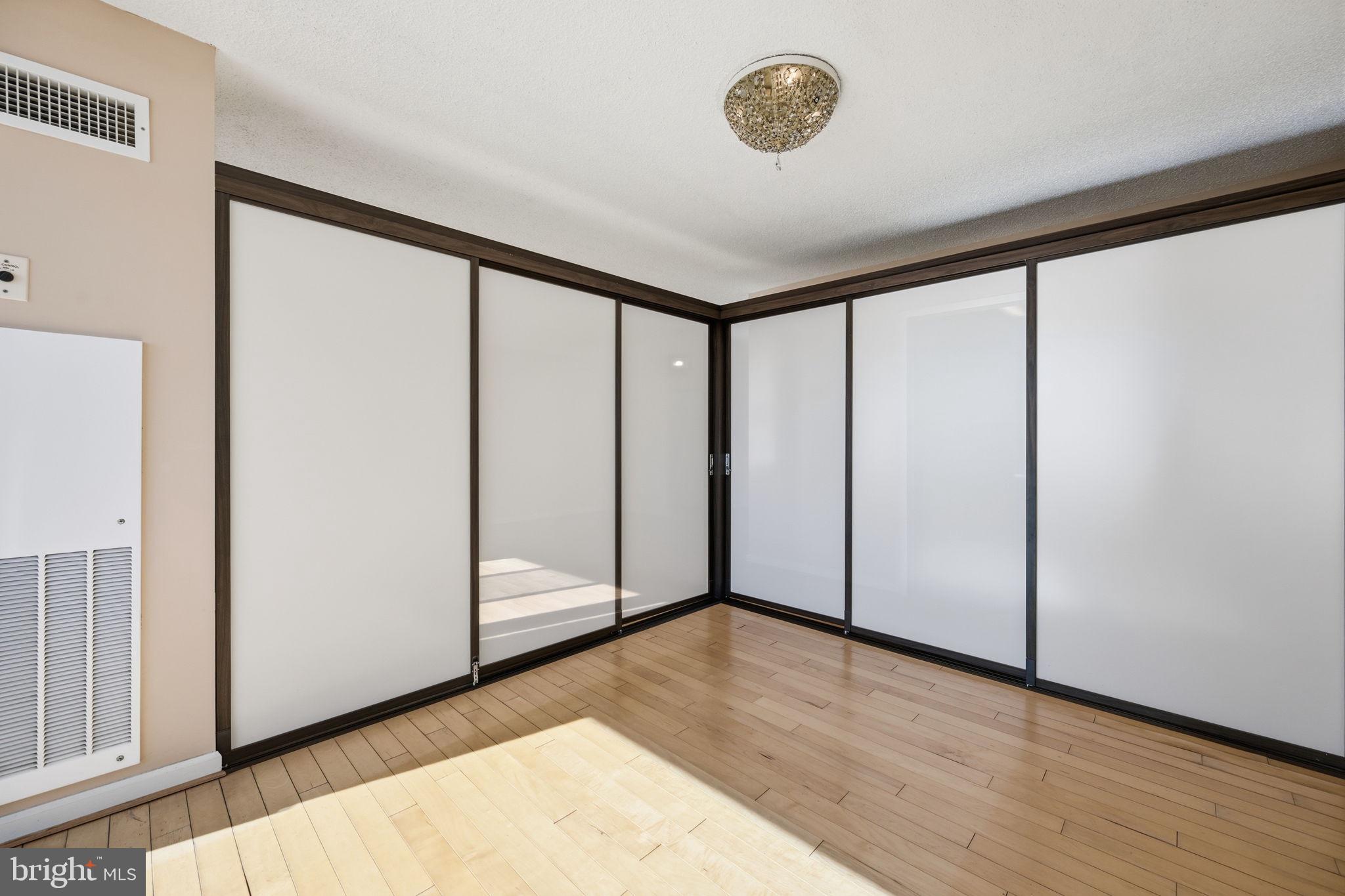 5225 Pooks Hill Road, Unit 519N Bethesda, MD 20814 - Photo 12 of 56 an empty room with wooden floor and windows