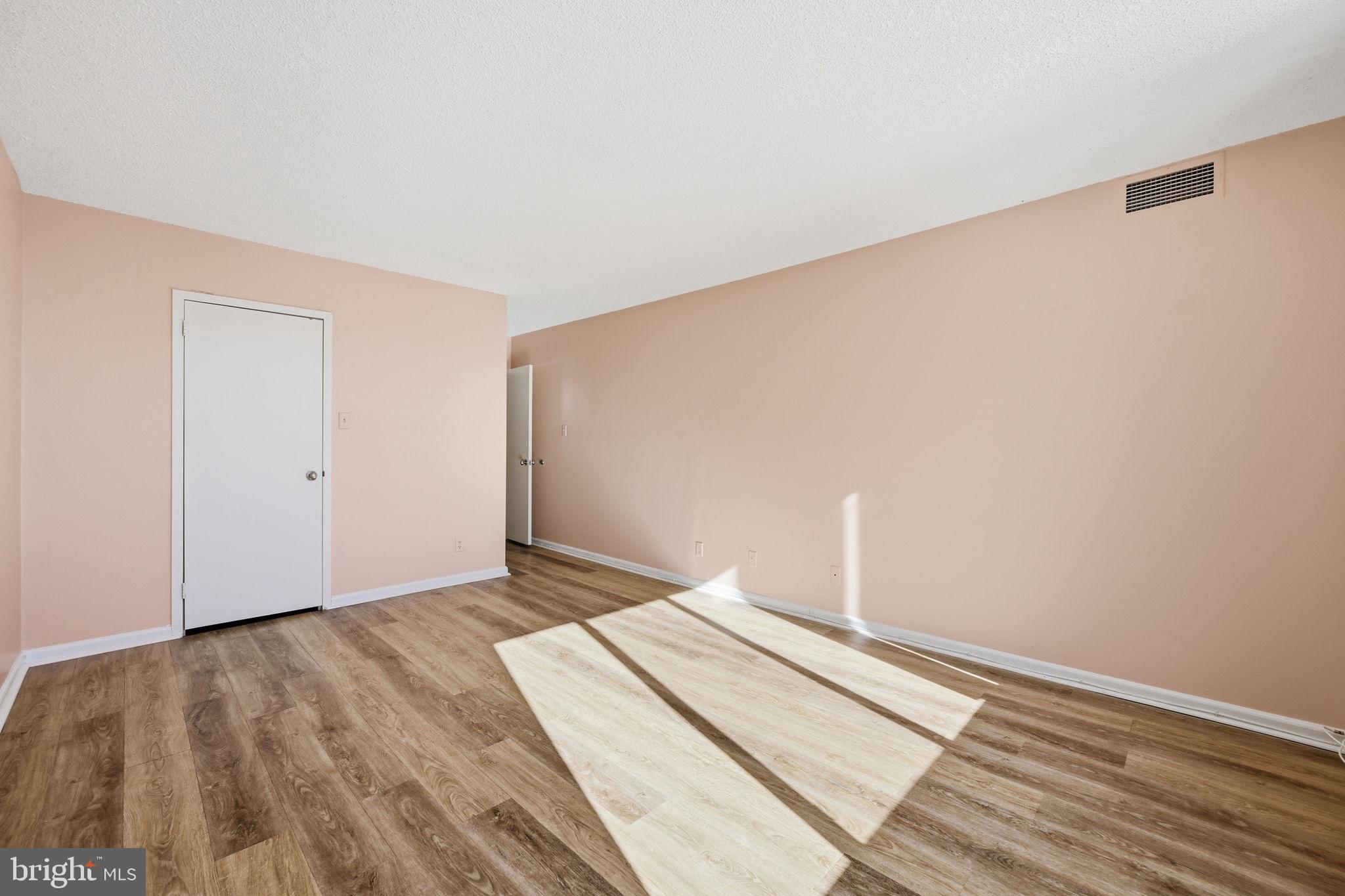 5225 Pooks Hill Road, Unit 519N Bethesda, MD 20814 - Photo 14 of 56 a bedroom with a bed and a wooden floor