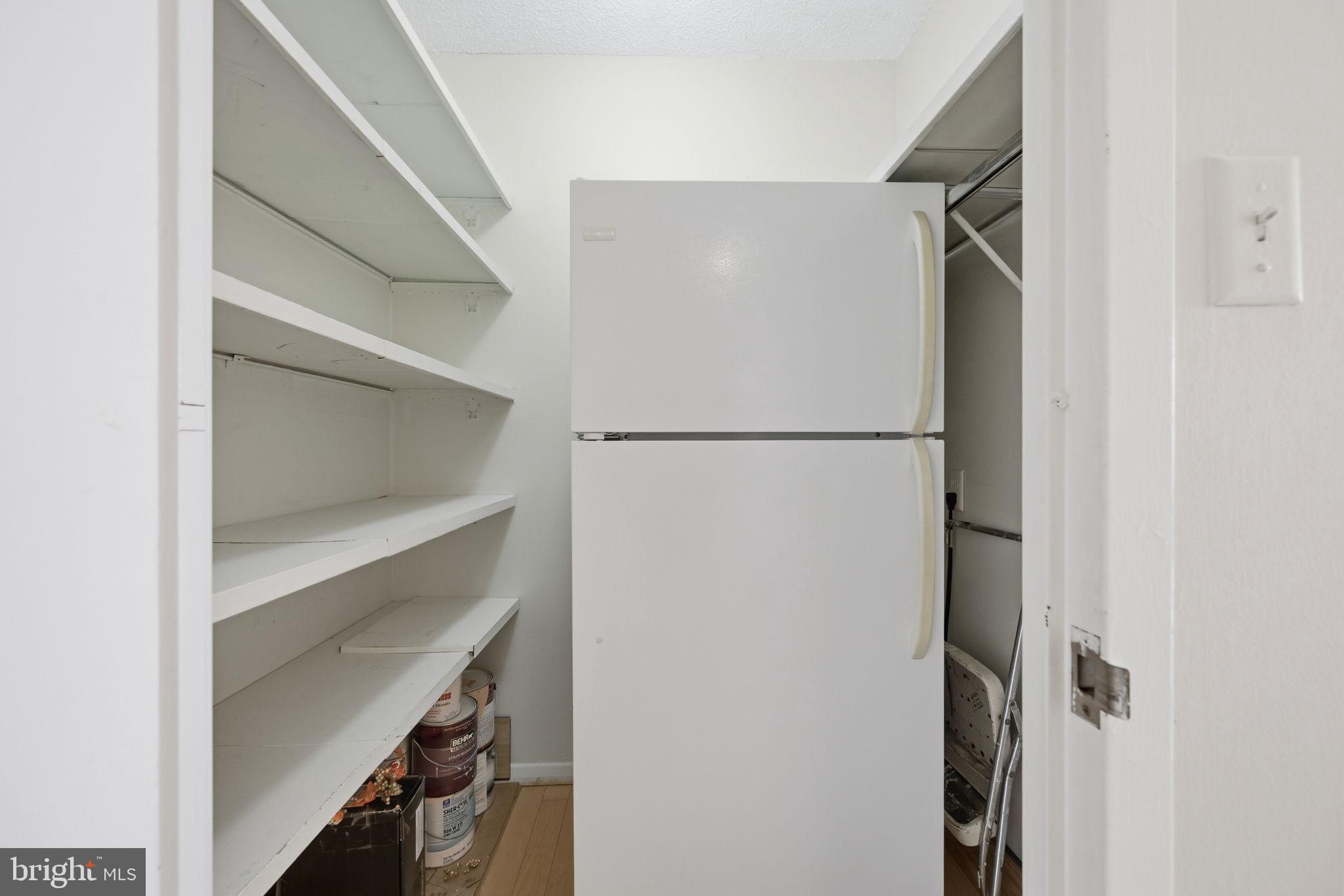 5225 Pooks Hill Road, Unit 519N Bethesda, MD 20814 - Photo 18 of 56 a white refrigerator freezer and a dishwasher sitting inside of a kitchen