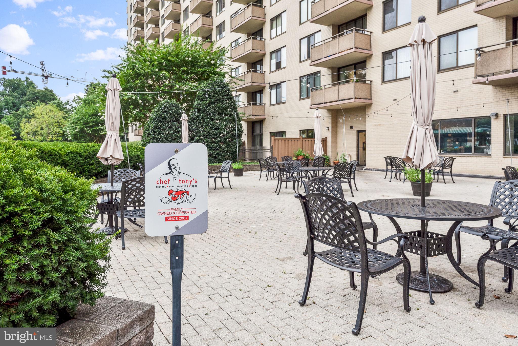 5225 Pooks Hill Road, Unit 519N Bethesda, MD 20814 - Photo 41 of 56 a table and chairs sitting in front of a building