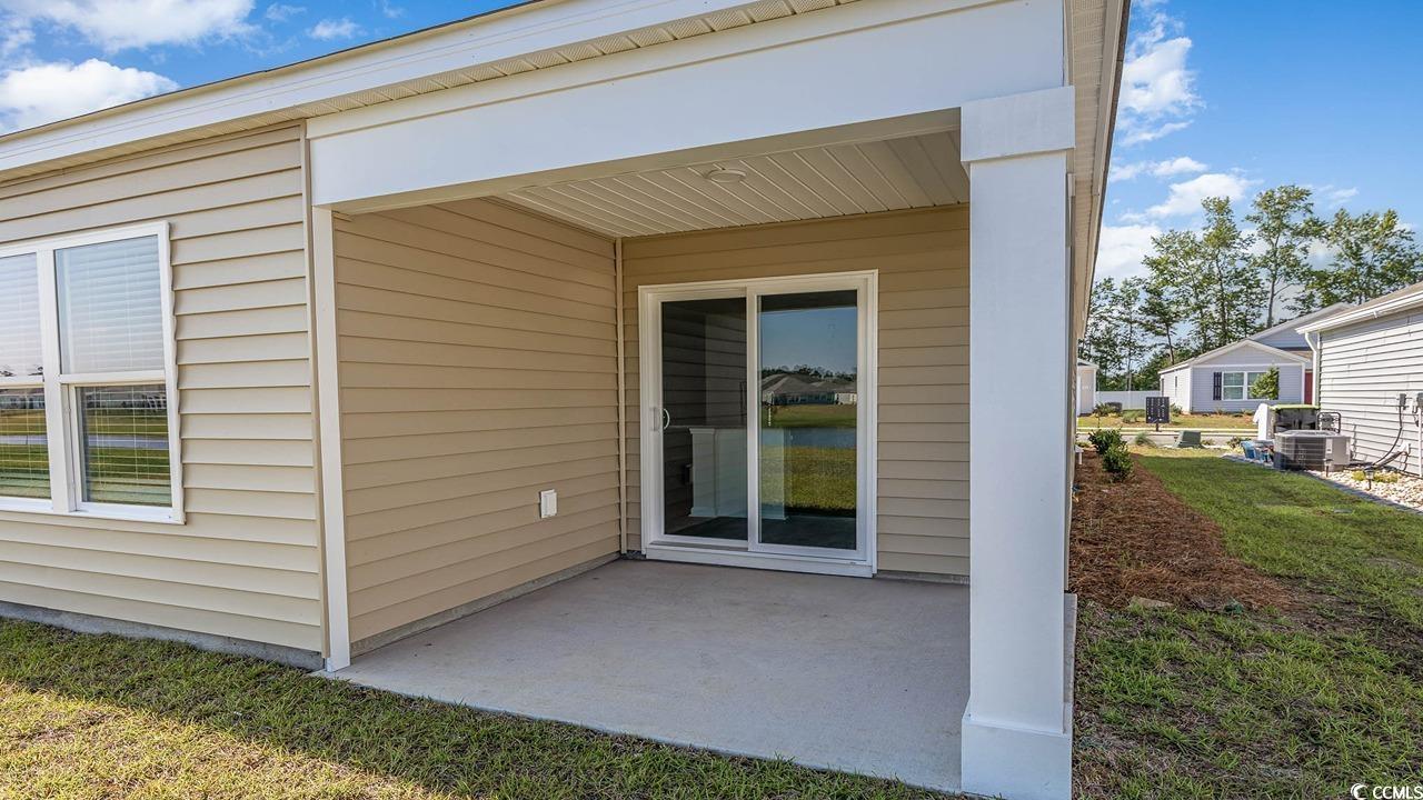 315 Skyward Street Myrtle Beach, SC 29588 - Photo 26 of 26 Entrance to property with a yard and a patio area