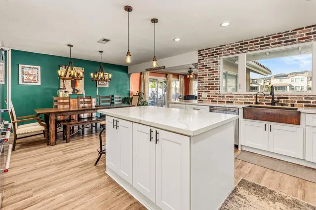 a kitchen with stainless steel appliances granite countertop a stove and cabinets