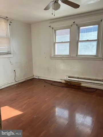 a view of a room with wooden floor and cabinet