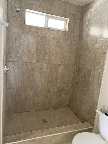 a bathroom with a shower and a toilet