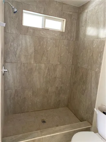 a bathroom with a shower and a toilet