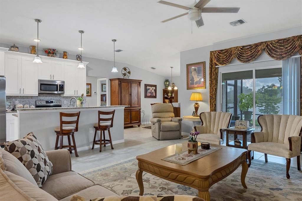 2694 Hopwood Road North Port, FL 34287 - Photo 13 of 56 a living room with furniture kitchen view and a chandelier