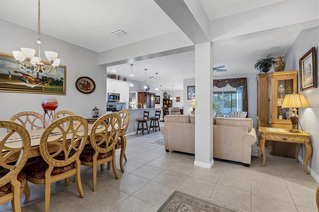 2694 Hopwood Road North Port, FL 34287 - Photo 16 of 56 a view of a dining room and livingroom with furniture wooden floor a chandelier