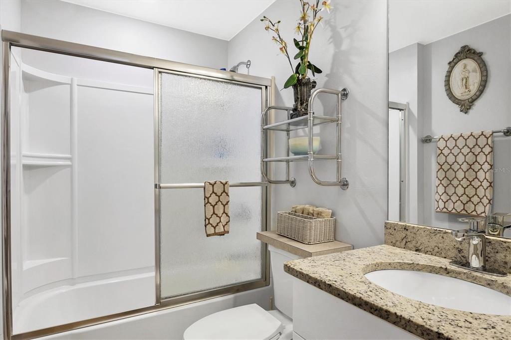 2694 Hopwood Road North Port, FL 34287 - Photo 27 of 56 a bathroom with a granite countertop sink mirror vanity and toilet