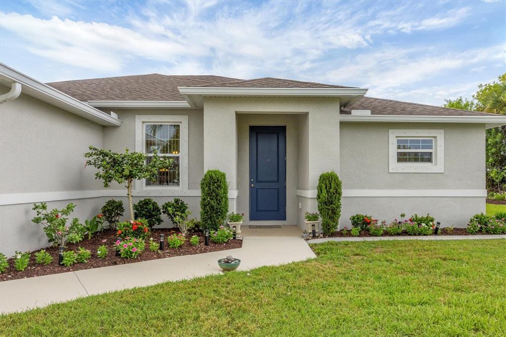 2694 Hopwood Road North Port, FL 34287 - Photo 4 of 56 a front view of a house with a yard