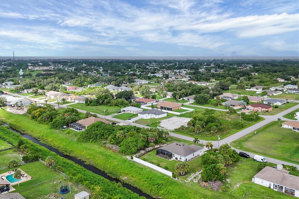 2694 Hopwood Road North Port, FL 34287 - Photo 42 of 56 an aerial view of residential houses with outdoor space and trees