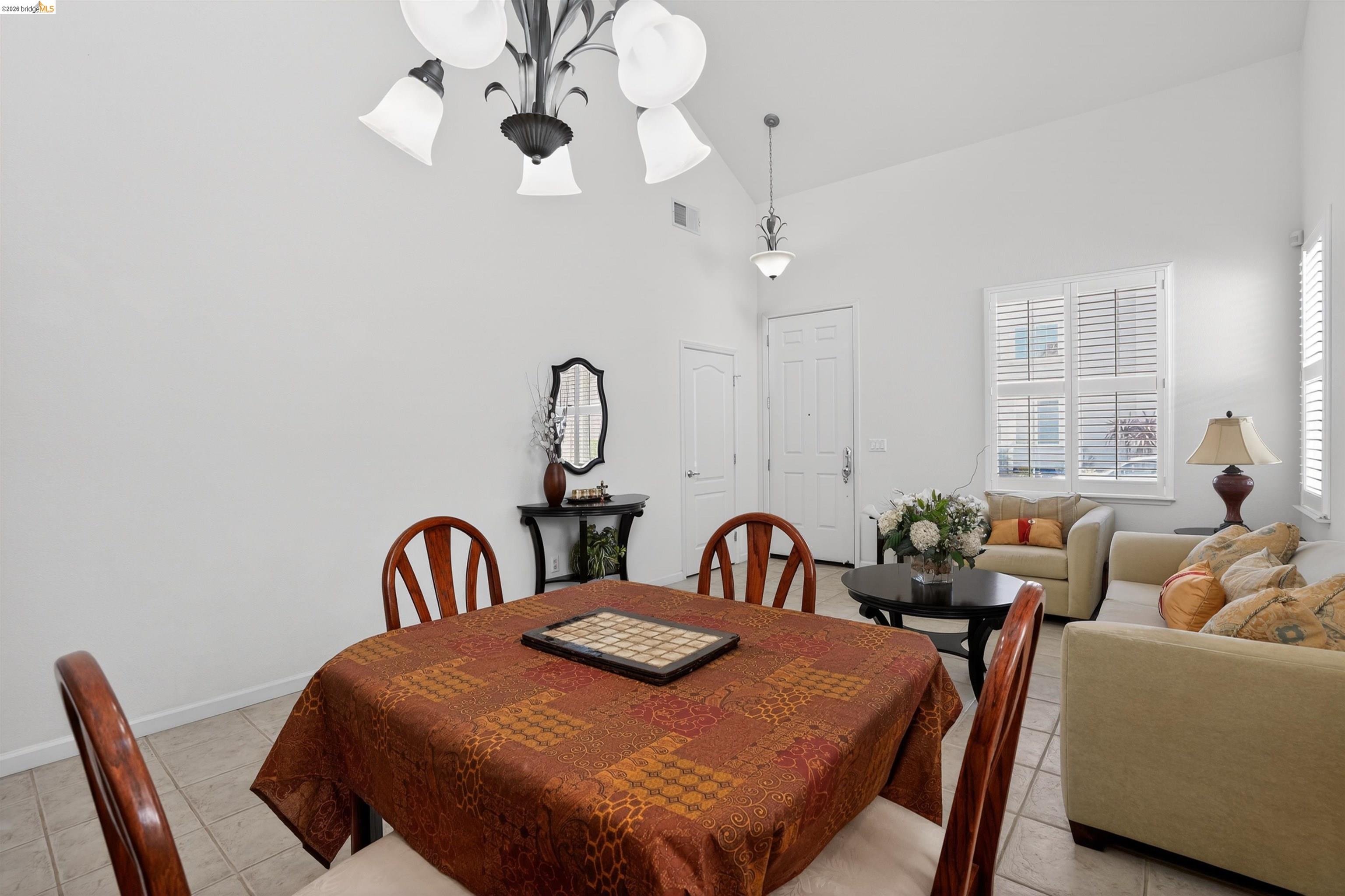1221 Andrea Way Vallejo, CA 94591 - Photo 6 of 29 Vaulted ceilings accentuate the open concept living and dining areas, featuring tile flooring and white plantation shutters