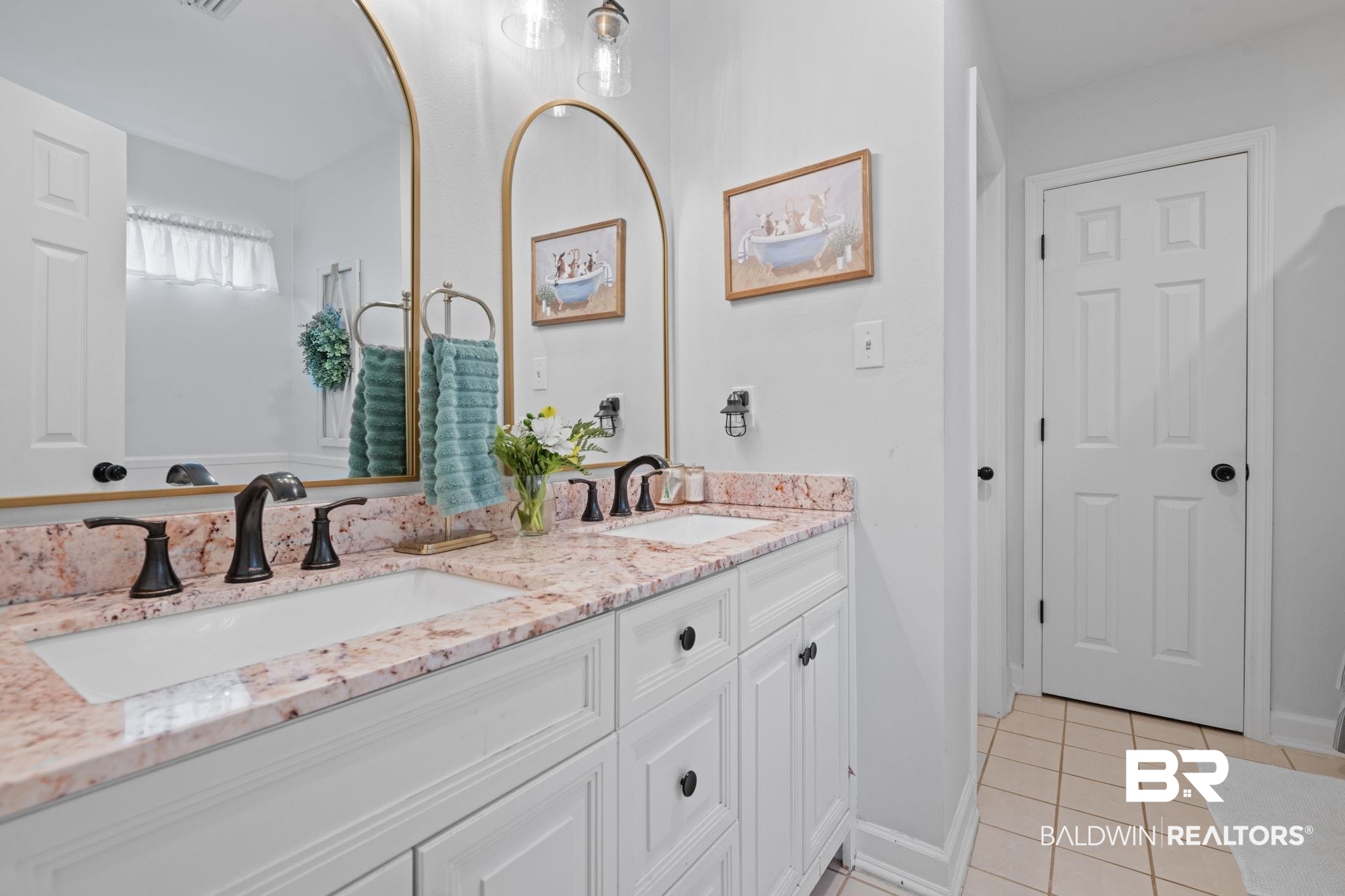 5936 Lundy Road Theodore, AL 36582 - Photo 14 of 32 Double vanity featuring a light-colored countertop with natural variations, dual integrated sinks, and bronze-finish faucets