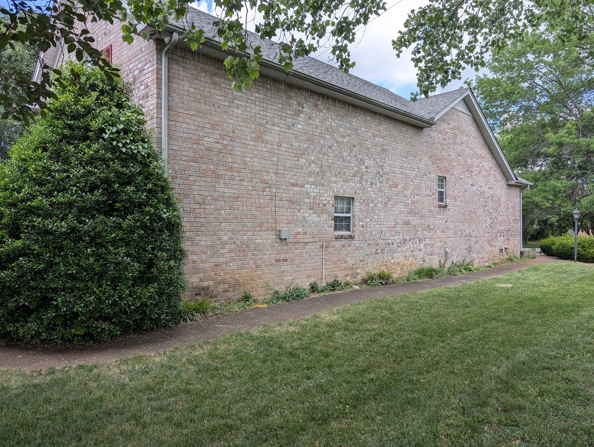 1401 Joe Pyron Drive Madison, TN 37115 - Photo 5 of 12 a brick house with a yard plants and large trees