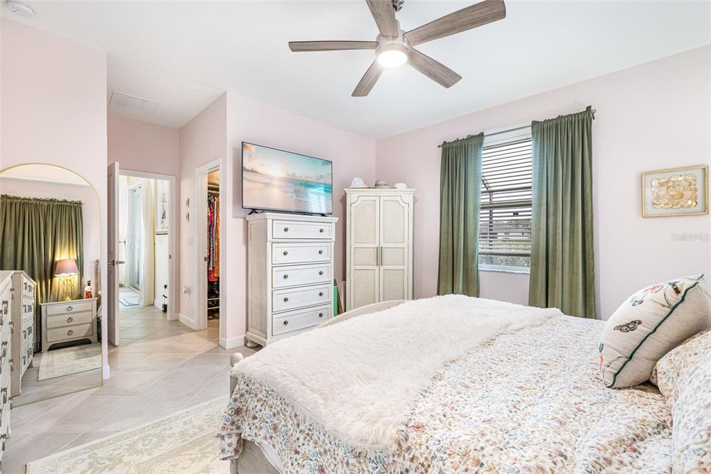 17424 Muscat Lane Punta Gorda, FL 33955 - Photo 17 of 32 a bedroom with a bed and a chandelier