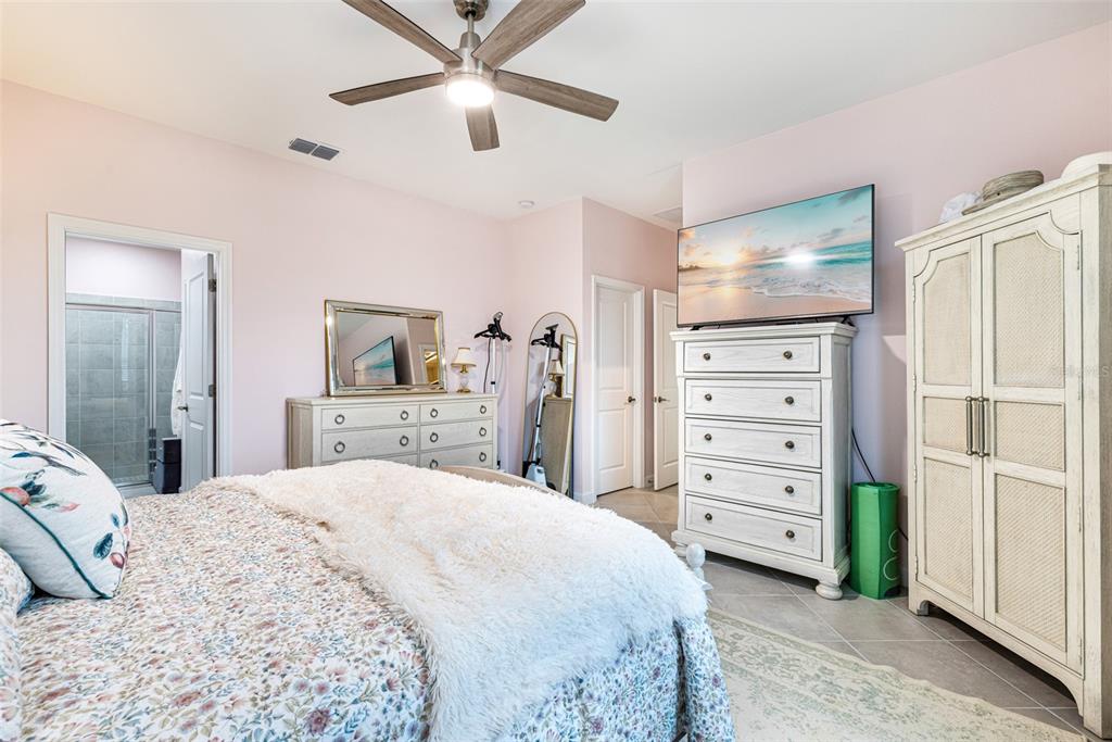 17424 Muscat Lane Punta Gorda, FL 33955 - Photo 18 of 32 a bedroom with a bed and a dresser