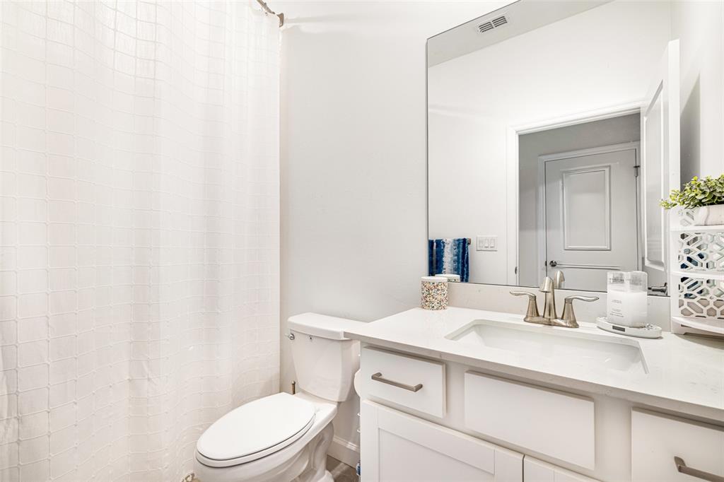 17424 Muscat Lane Punta Gorda, FL 33955 - Photo 20 of 32 a bathroom with a sink a toilet a mirror and vanity