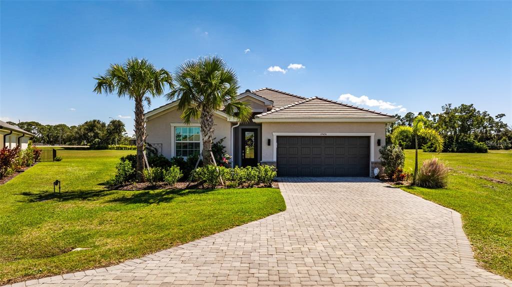 17424 Muscat Lane Punta Gorda, FL 33955 - Photo 2 of 32 a front view of a house with a yard and garage