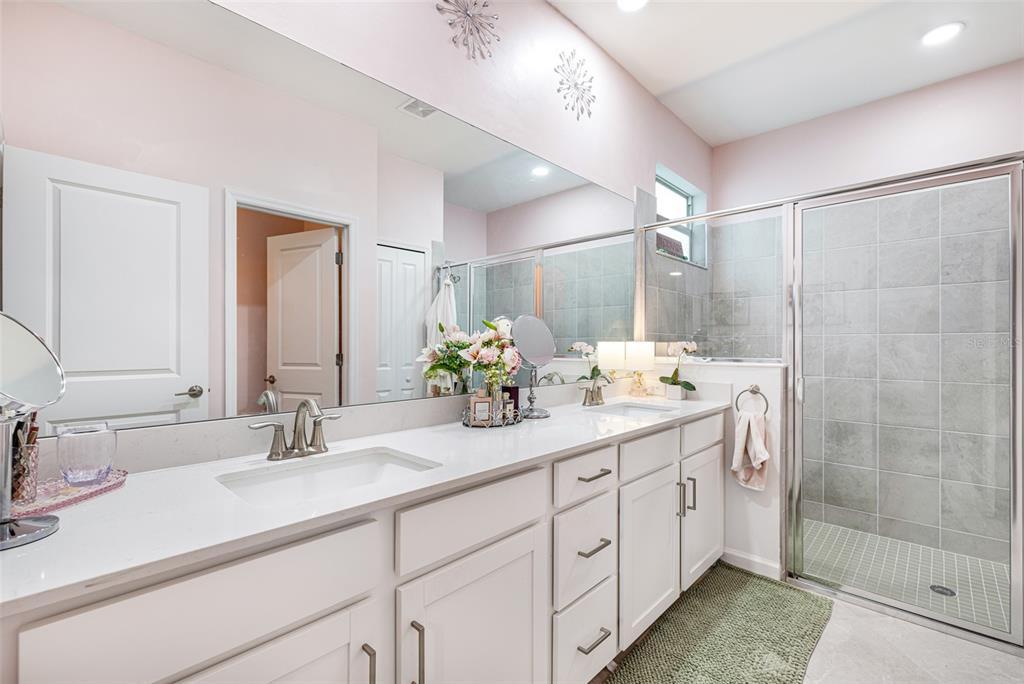 17424 Muscat Lane Punta Gorda, FL 33955 - Photo 21 of 32 a bathroom with double sink and a mirror