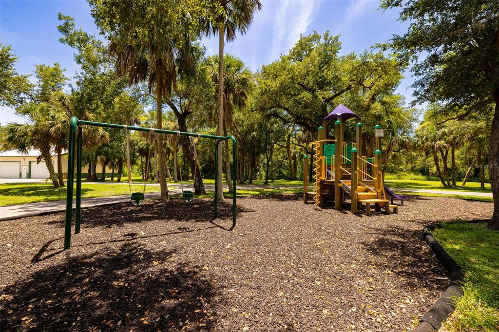 17424 Muscat Lane Punta Gorda, FL 33955 - Photo 29 of 32 a view of a park with swings and slides