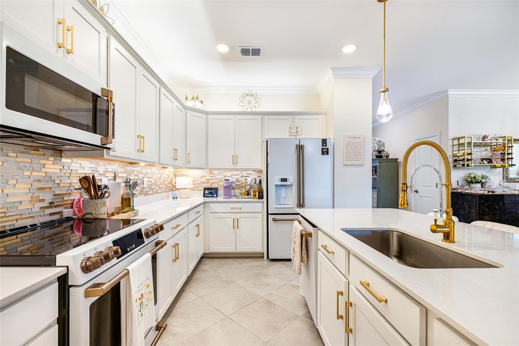 17424 Muscat Lane Punta Gorda, FL 33955 - Photo 8 of 32 a kitchen with a sink a stove and refrigerator