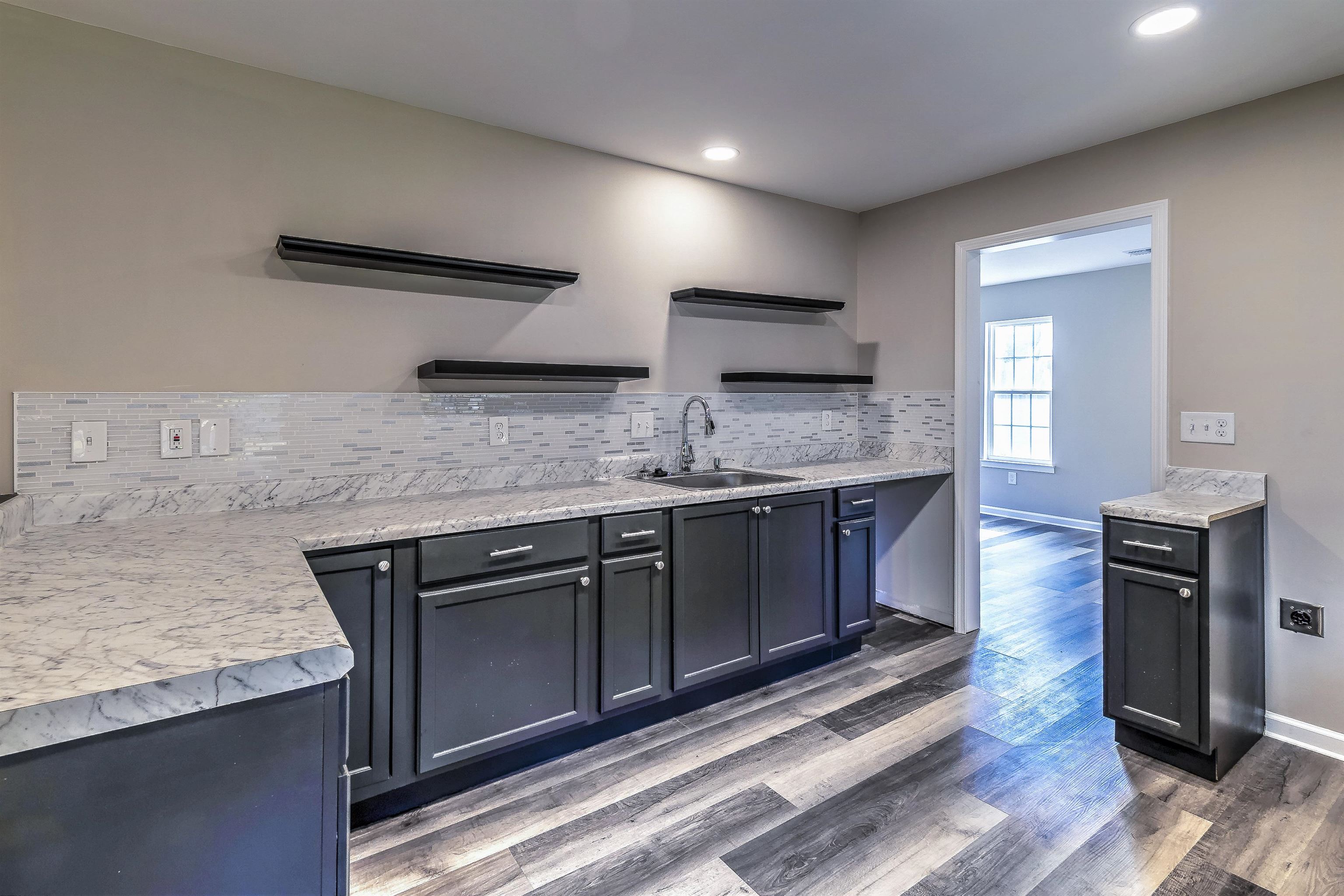 1494 Abernathy Road Memphis, TN 38116 - Photo 13 of 35 a kitchen with stainless steel appliances granite countertop a sink stove and microwave