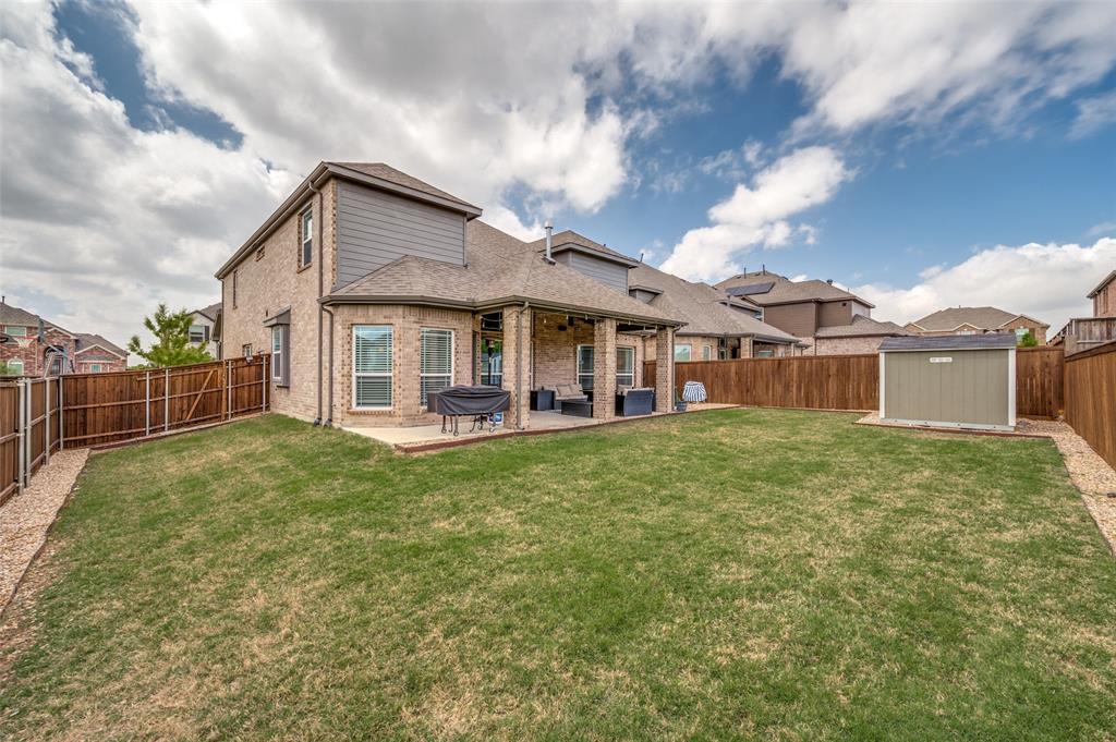 808 Violet Way Celina, TX 75009 - Photo 24 of 30 Back of house with extended fenced in backyard, and an extra concrete pad for grilling. Also plumbed for gas in backyard.