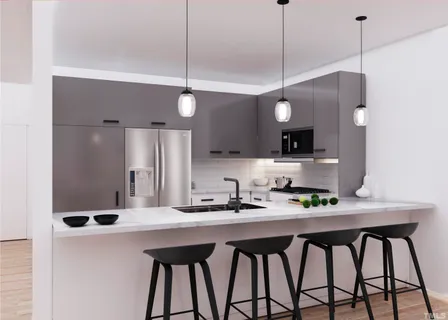 a kitchen with stainless steel appliances a sink a refrigerator and a stove