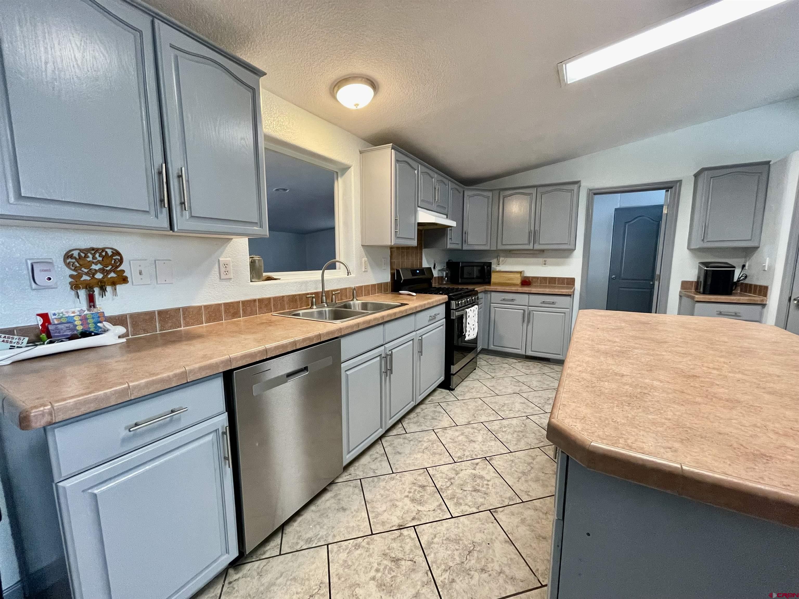 18817 D Road Delta, CO 81416 - Photo 11 of 35 a kitchen with stainless steel appliances granite countertop a sink stove and refrigerator