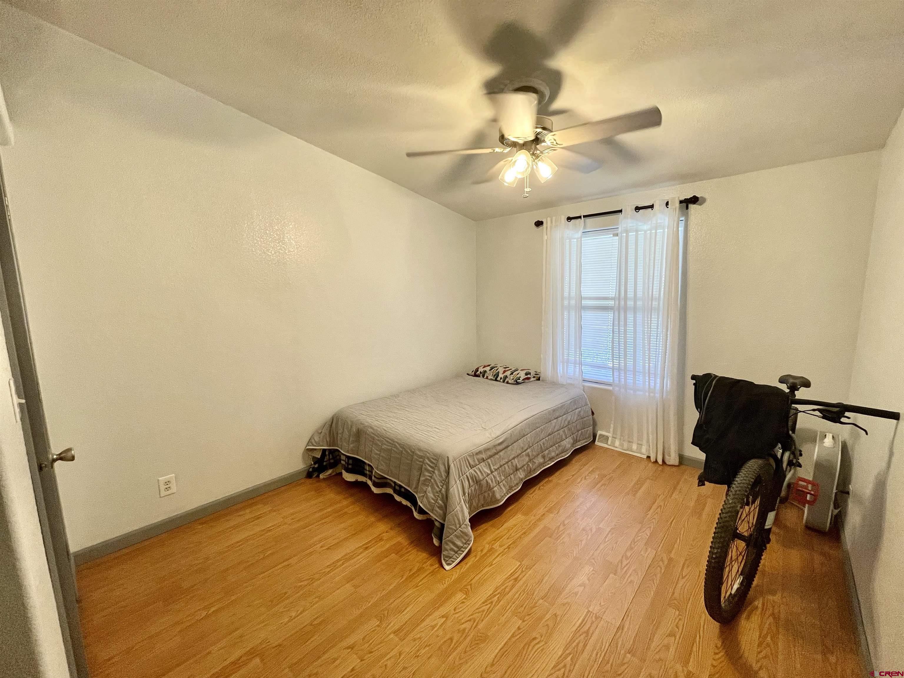 18817 D Road Delta, CO 81416 - Photo 20 of 35 a bedroom with a bed and a ceiling fan