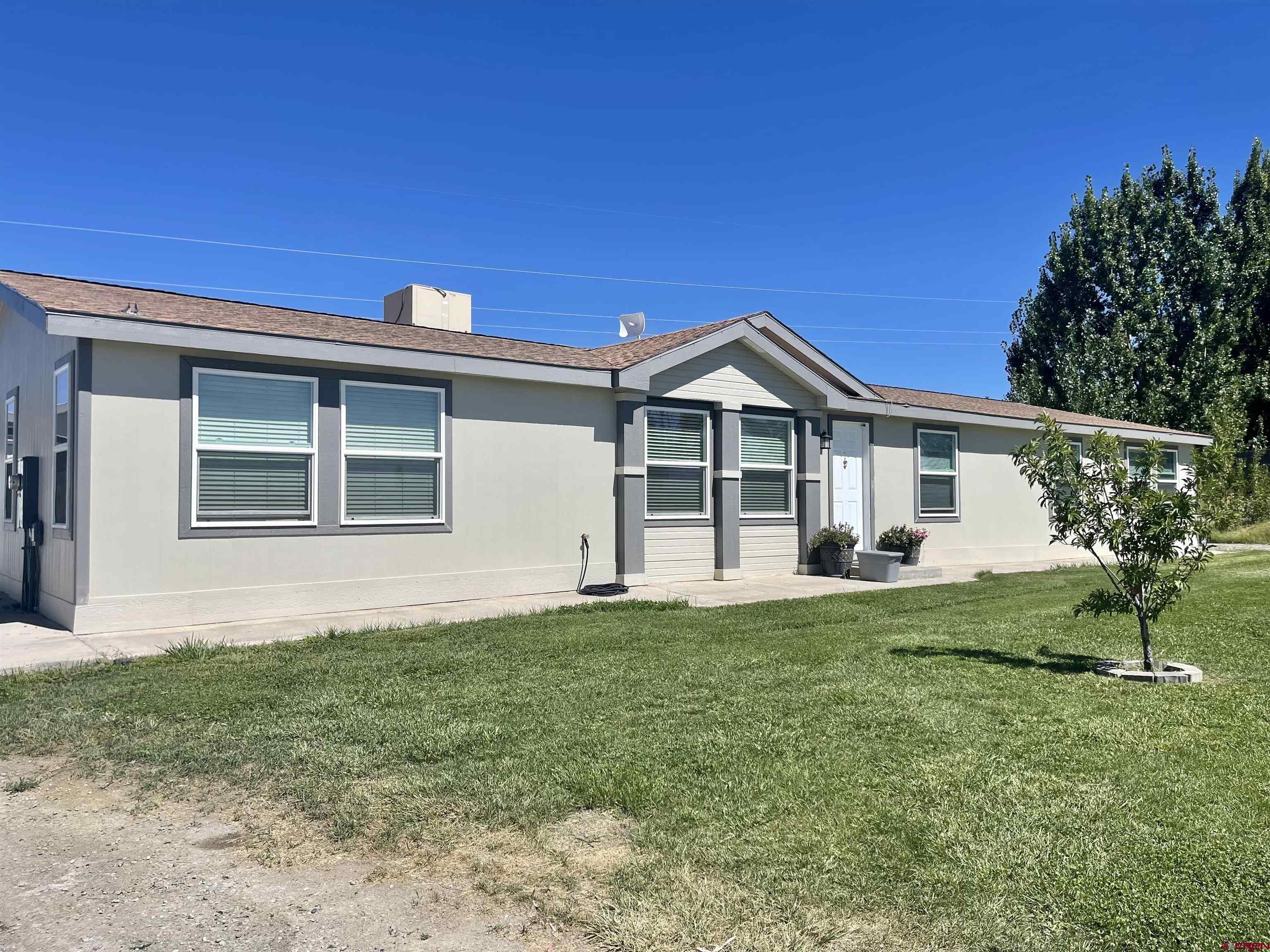 18817 D Road Delta, CO 81416 - Photo 2 of 35 a front view of a house with a garden