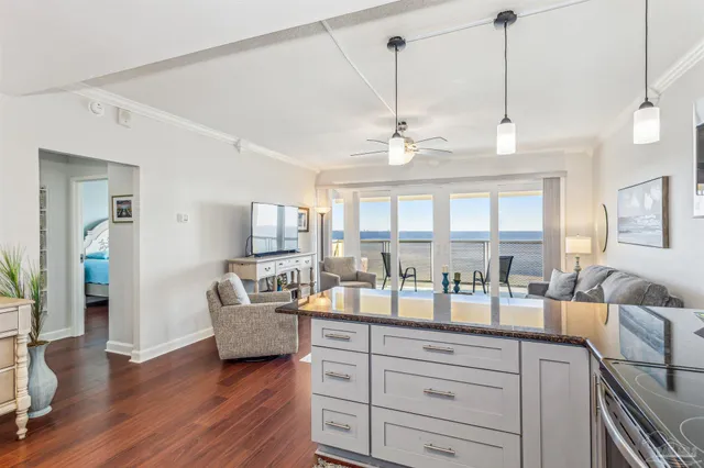 a living room with kitchen island furniture and a chandelier