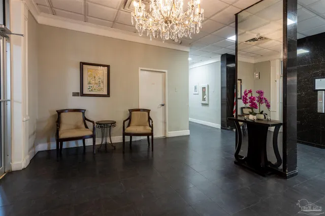 a kitchen area with stainless steel appliances kitchen island granite countertop a refrigerator a stove and a dining table with wooden floor