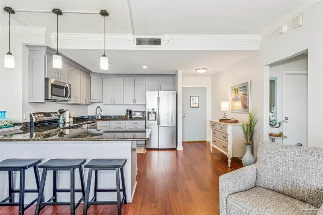 a large kitchen with a table and chairs