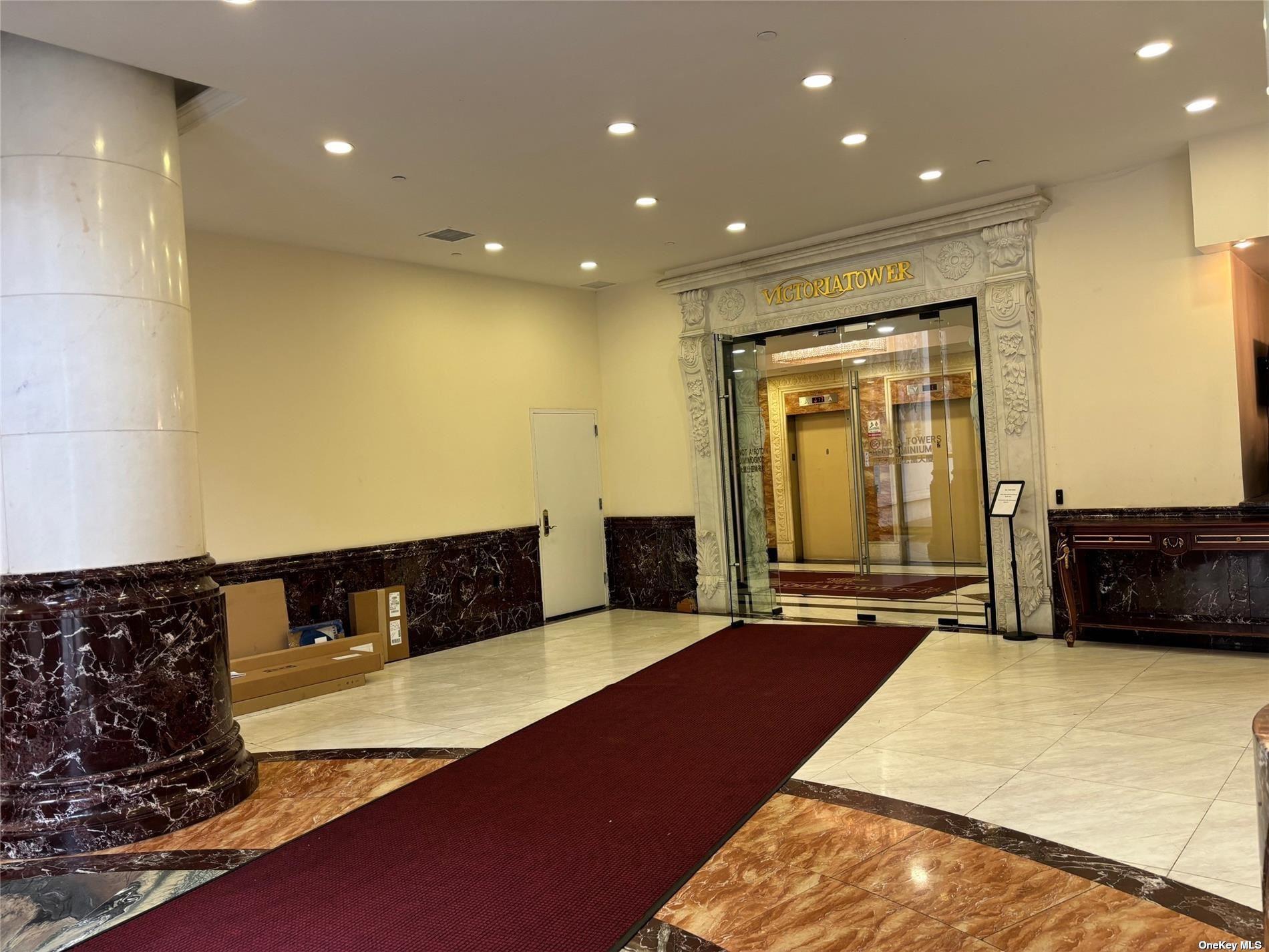 133-38 Sanford Avenue, Unit 9C Queens, NY 11355 - Photo 6 of 9 a living room with a couch and a flat screen tv