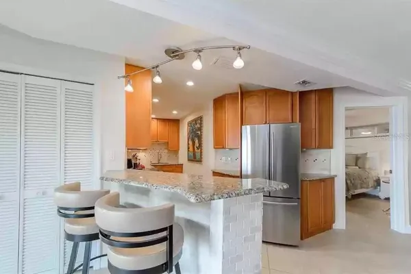a kitchen with stainless steel appliances granite countertop a sink a stove and cabinets