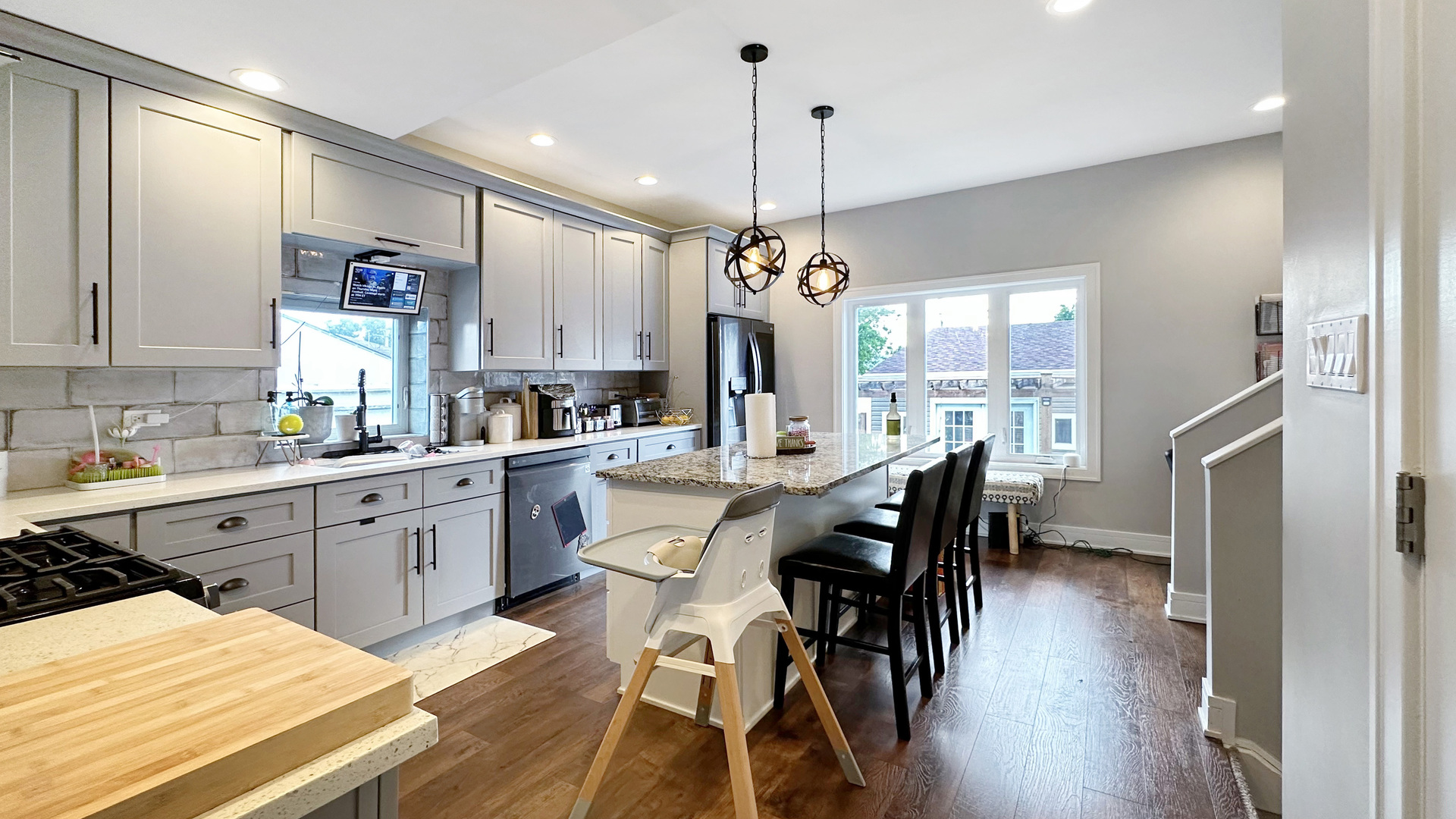 8211 43rd Place Lyons, IL 60534 - Photo 13 of 29 a kitchen with stainless steel appliances kitchen island granite countertop a dining table chairs stove a sink and a window