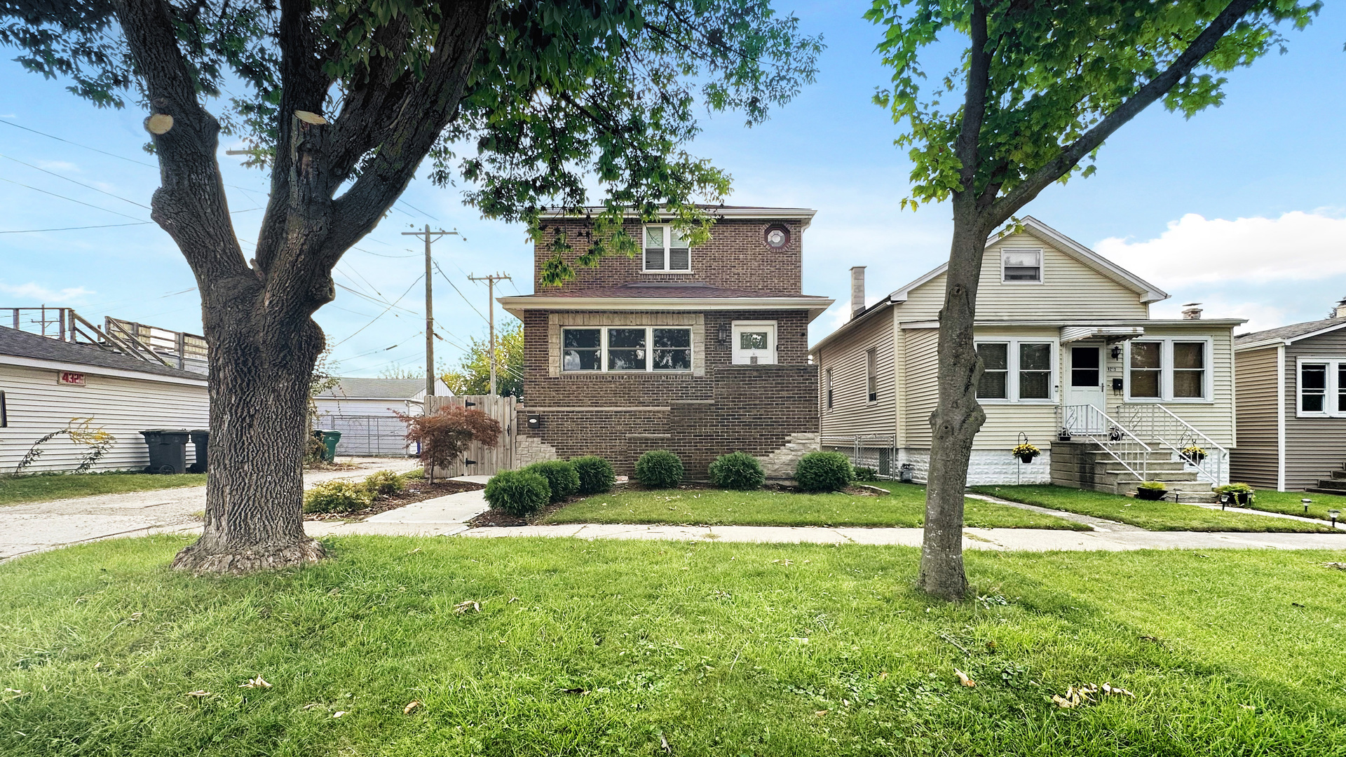 8211 43rd Place Lyons, IL 60534 - Photo 2 of 29 a front view of a house with a yard