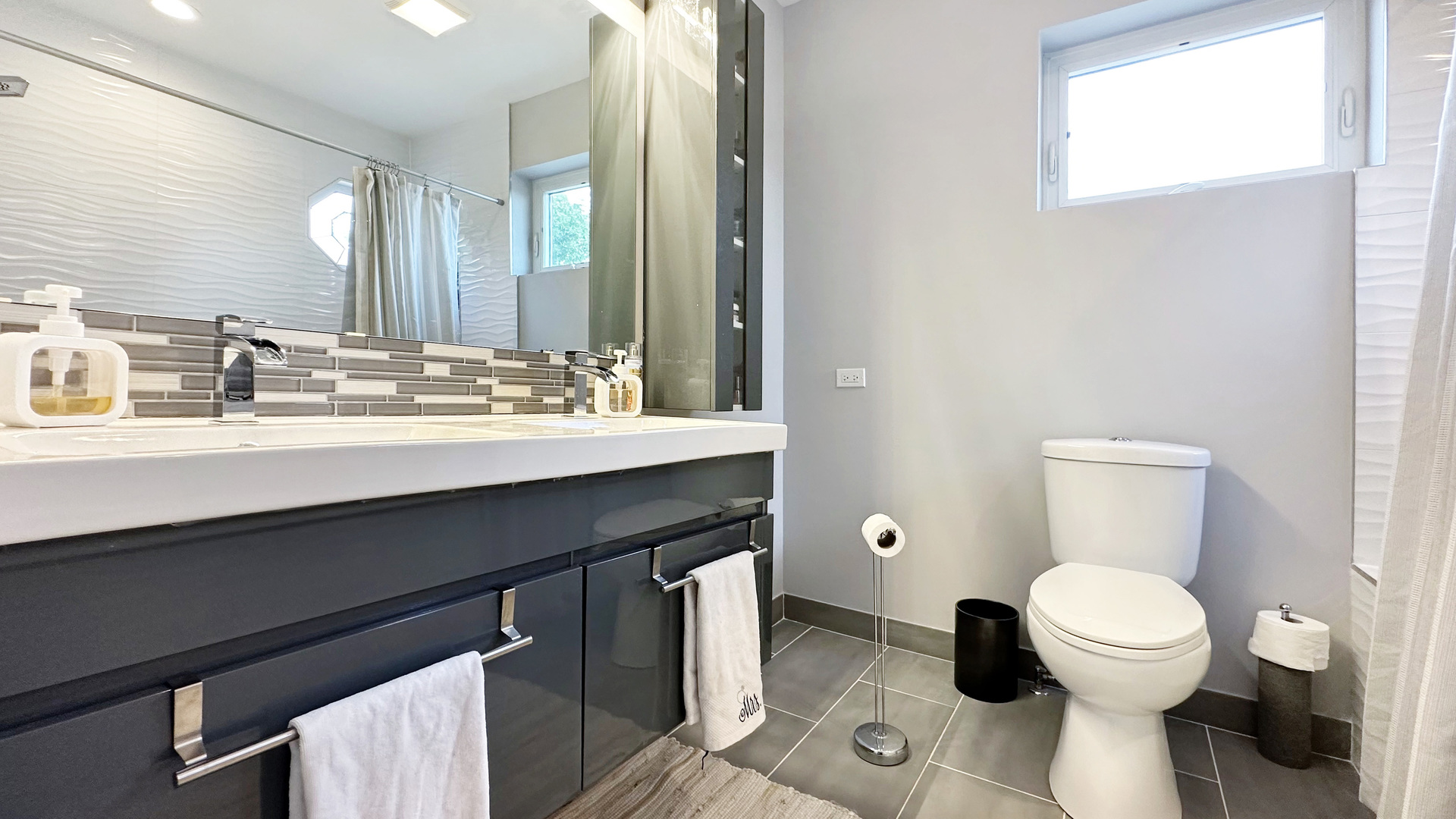 8211 43rd Place Lyons, IL 60534 - Photo 23 of 29 a bathroom with a toilet sink and mirror