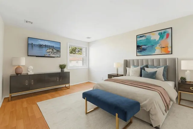 a bedroom with a bed and a couch