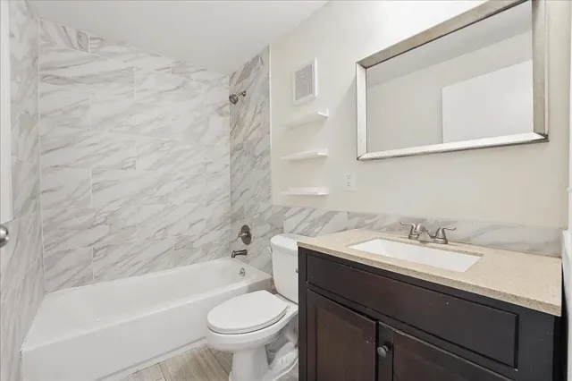 a bathroom with a sink a toilet and a bathtub