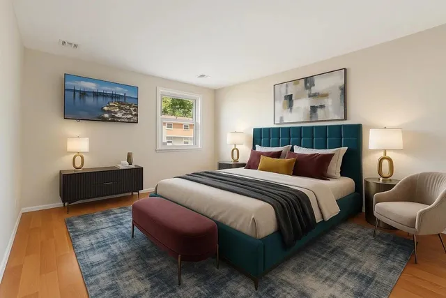 a bedroom with bed and a couch